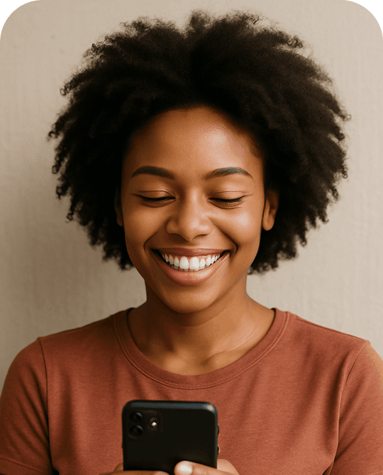 image of black woman smiling holding her phone